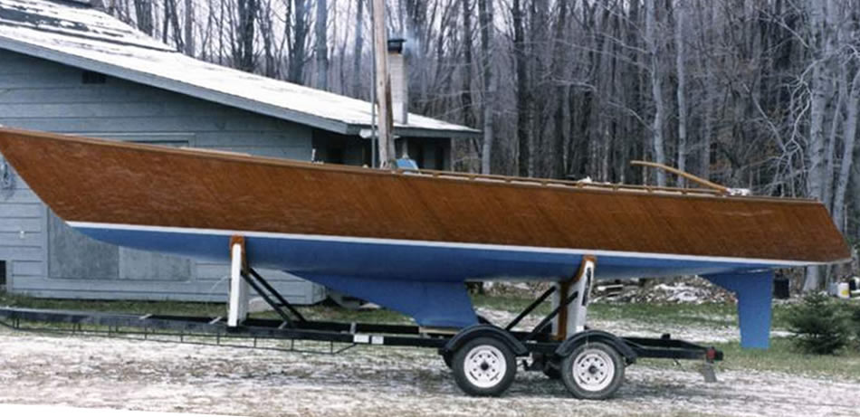 Wooden sailboat with custom trailer.