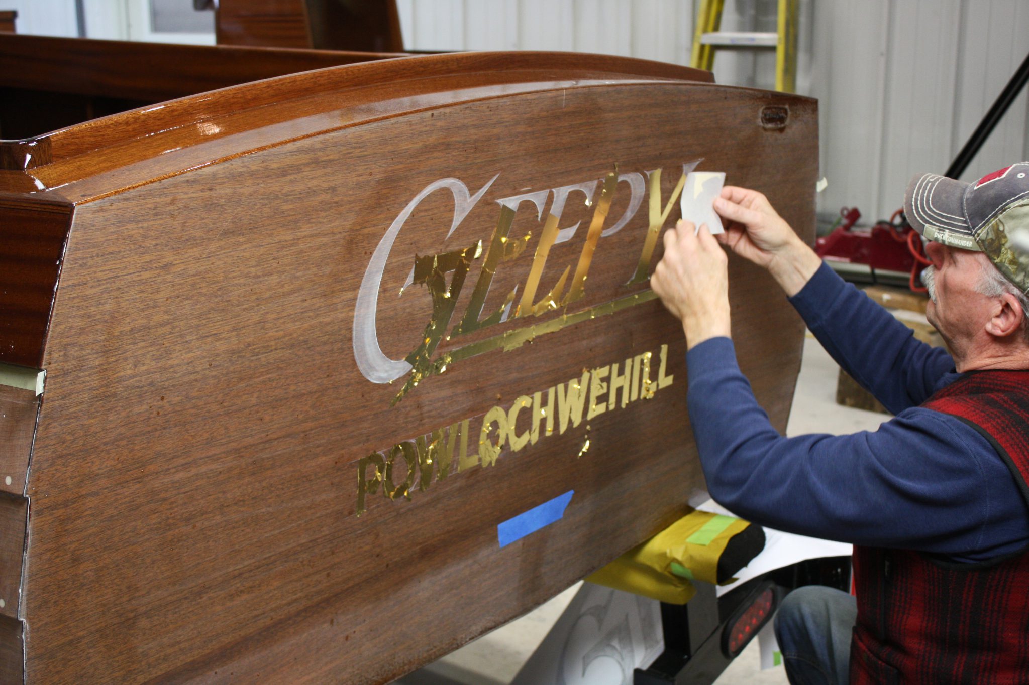 23 karat gold leaf being applied to transom of Geepy